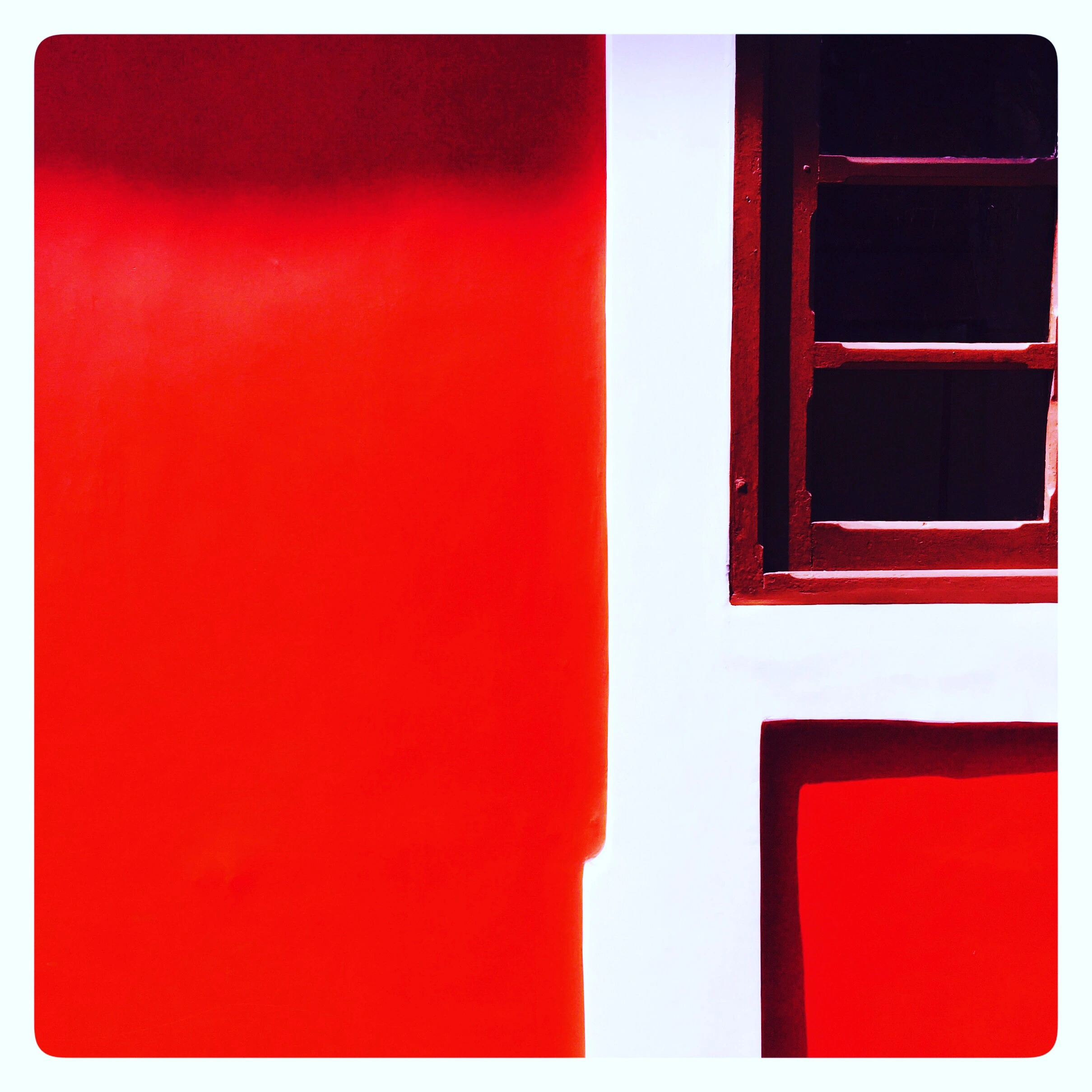 partial photo of a brown tinted window of a house with red walls and white borders, abstract art showcasing some colourful violence